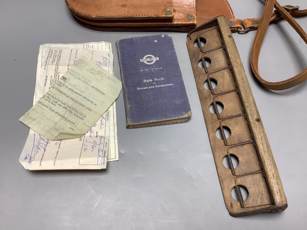 A 1950's London Transport bus conductor's satchel, ticket holder and rule book